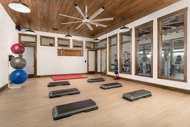 workout area featuring hardwood / wood-style flooring and wooden ceiling