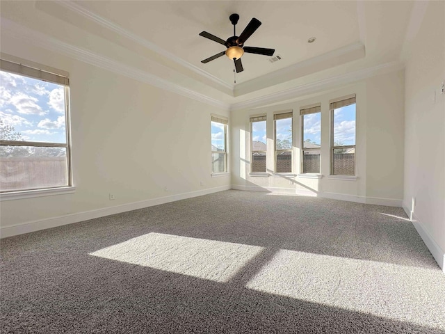 spare room with a tray ceiling, crown molding, ceiling fan, and carpet flooring