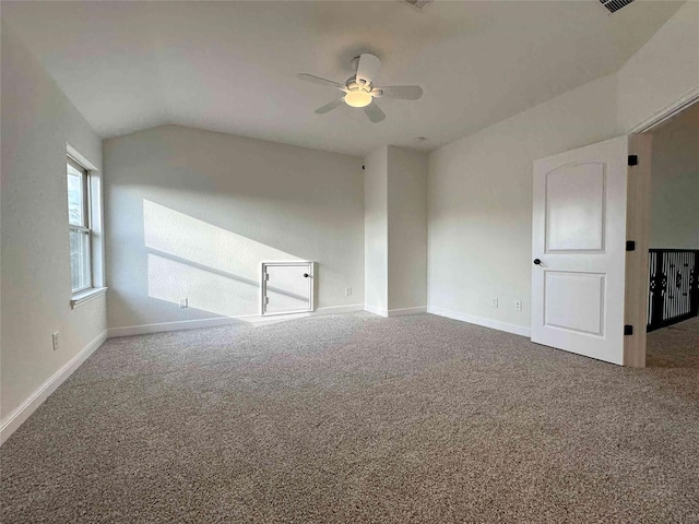 unfurnished room featuring ceiling fan, lofted ceiling, and carpet flooring