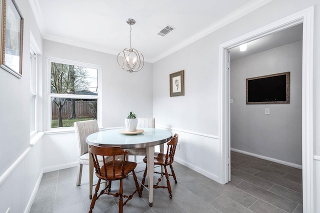 dining space featuring an inviting chandelier, tile patterned flooring, and ornamental molding