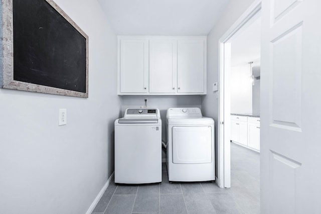 laundry area with cabinets, light tile patterned floors, and independent washer and dryer