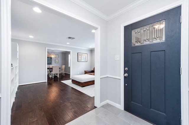 foyer featuring hardwood / wood-style flooring and ornamental molding