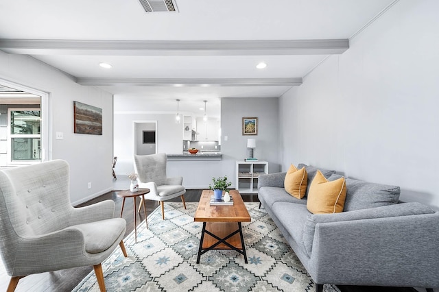 living room with hardwood / wood-style flooring and beam ceiling