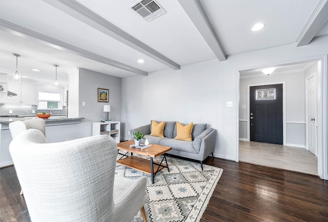 living room featuring dark hardwood / wood-style floors and beamed ceiling