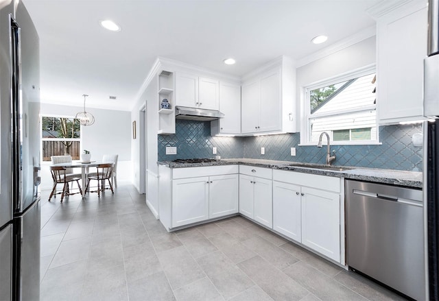 kitchen with sink, stainless steel appliances, white cabinets, and stone counters