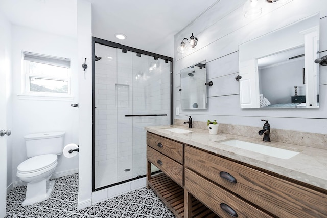 bathroom with vanity, a shower with shower door, tile patterned floors, and toilet