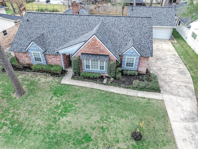 view of front of house featuring a garage and a front lawn