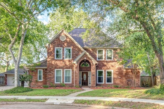 view of front of home featuring a garage and a front lawn