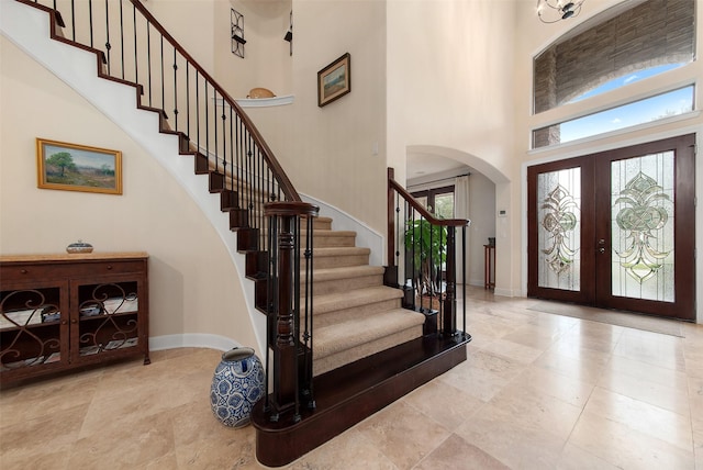 entrance foyer with french doors and a towering ceiling