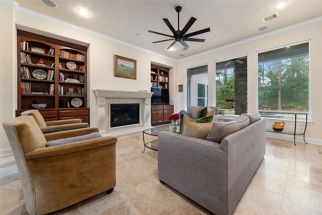 living room featuring built in shelves, ornamental molding, and ceiling fan