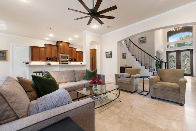 living room featuring ornamental molding, ceiling fan, and french doors