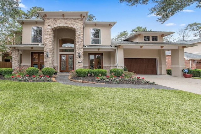 view of front of home with a garage, a front yard, and french doors