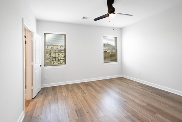 empty room with ceiling fan and light wood-type flooring