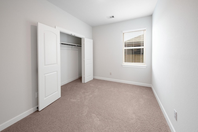 unfurnished bedroom featuring a closet and carpet