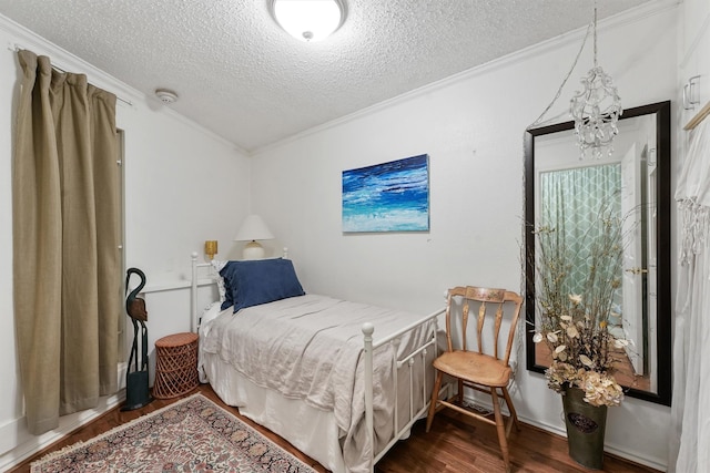 bedroom featuring crown molding, dark hardwood / wood-style floors, a notable chandelier, and a textured ceiling