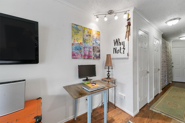 office area with hardwood / wood-style flooring, track lighting, and a textured ceiling