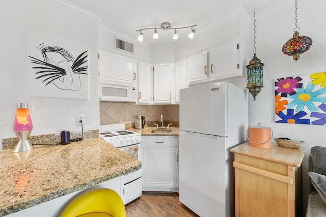 kitchen featuring sink, white cabinets, decorative backsplash, white appliances, and a textured ceiling