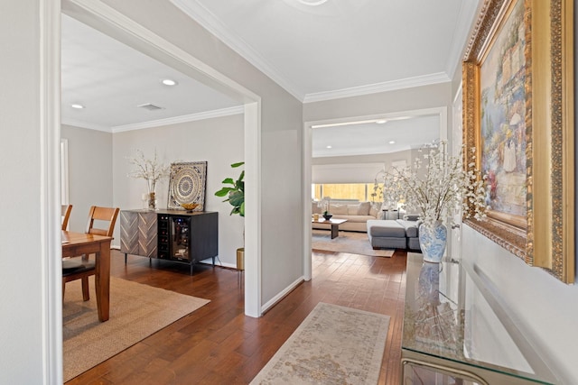 hallway with dark hardwood / wood-style flooring and ornamental molding