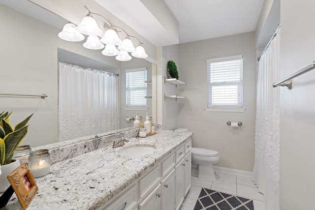 bathroom with vanity, a healthy amount of sunlight, tile patterned floors, and toilet