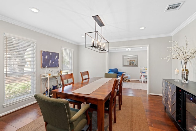 dining room with crown molding and dark hardwood / wood-style flooring