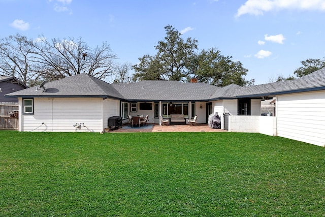 rear view of property with a yard, outdoor lounge area, and a patio