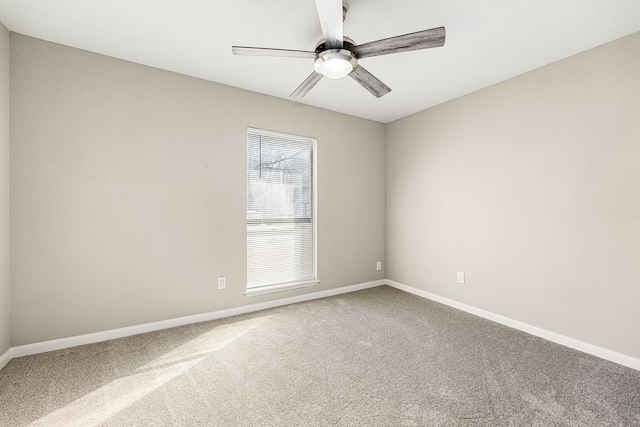 empty room with ceiling fan and carpet flooring