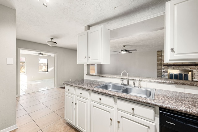 kitchen featuring sink, white cabinetry, tasteful backsplash, light tile patterned floors, and dishwasher