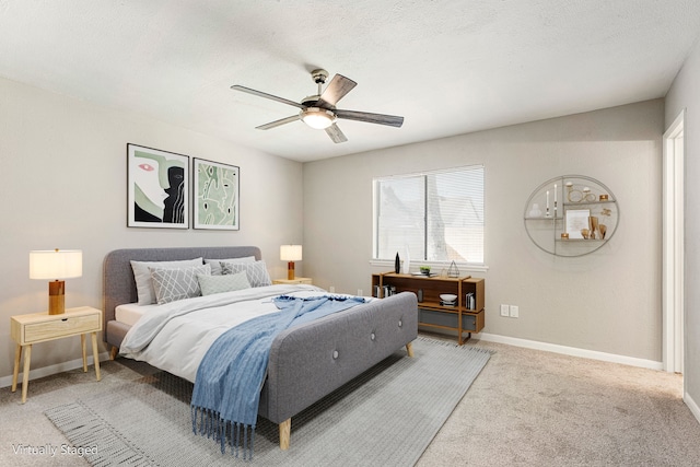 carpeted bedroom with ceiling fan and a textured ceiling