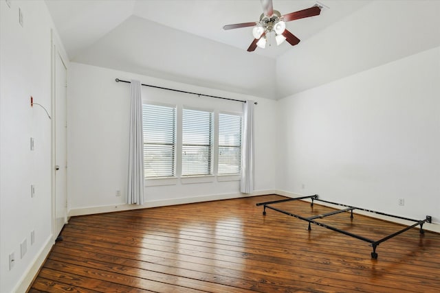 spare room featuring lofted ceiling, ceiling fan, hardwood / wood-style floors, and baseboards