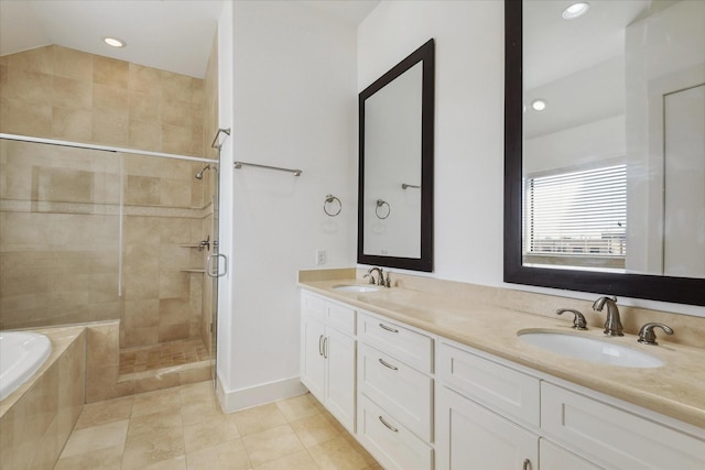 bathroom with a garden tub, tile patterned flooring, a sink, and a shower stall