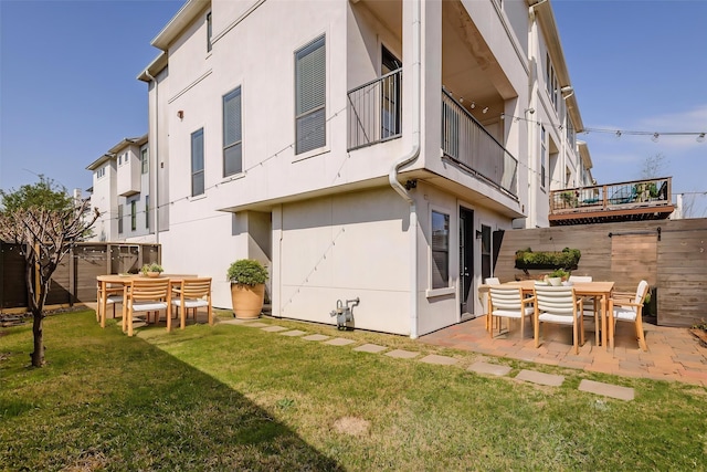 1819 Dart St, Houston, TX 77007 - rear view of house with stucco siding, a patio, and outdoor dining space