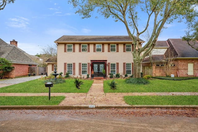 colonial home with a front yard