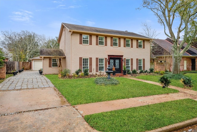 colonial house with a garage and a front yard