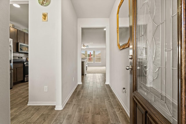 hallway with hardwood / wood-style floors