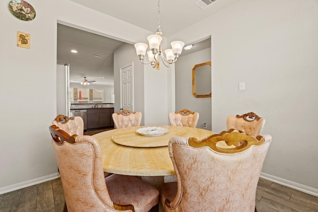 dining room featuring an inviting chandelier, dark hardwood / wood-style flooring, and sink