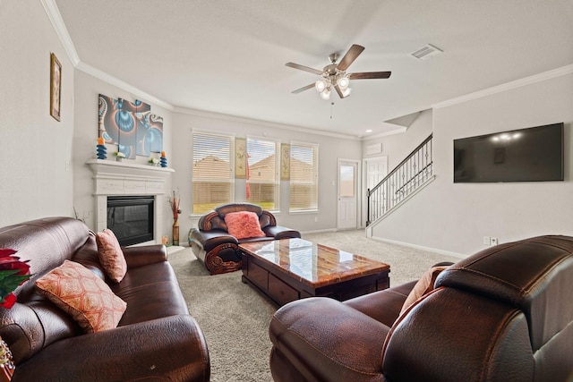 carpeted living room featuring ornamental molding and ceiling fan