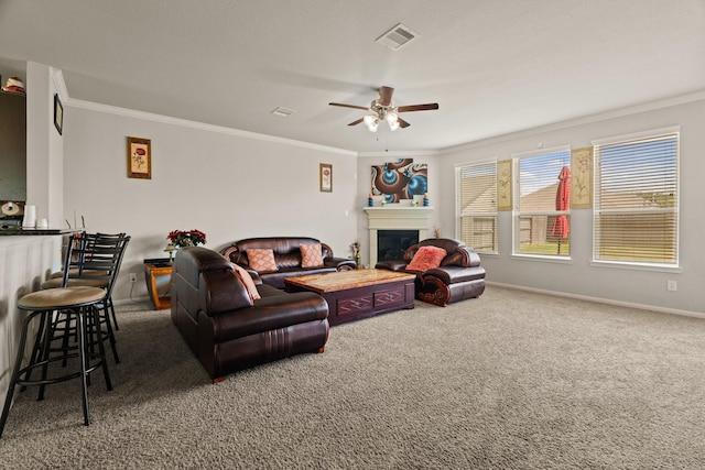 carpeted living room featuring crown molding and ceiling fan