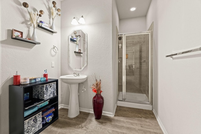 bathroom featuring wood-type flooring and walk in shower