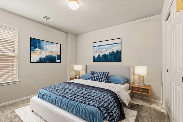 bedroom featuring light colored carpet and a closet