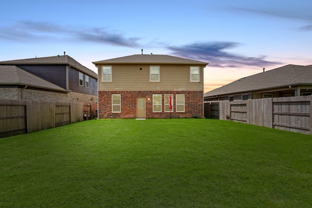 back house at dusk with a yard