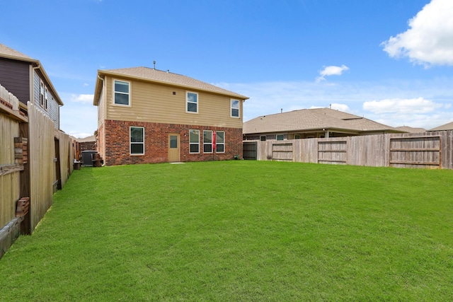 back of property with central AC and a yard