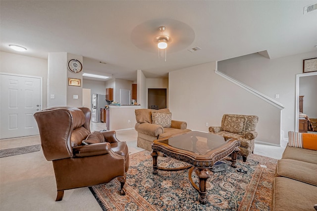 carpeted living room with ceiling fan