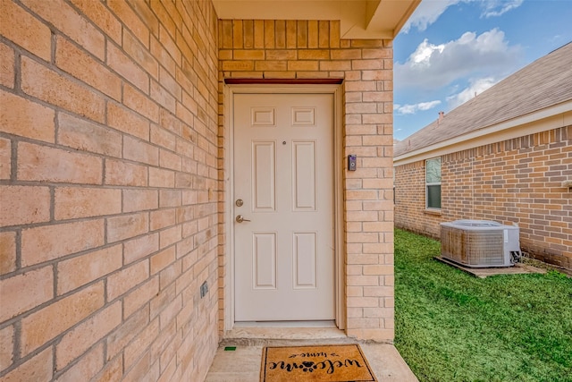 doorway to property featuring central air condition unit