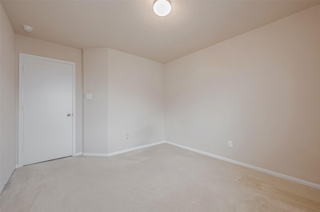 carpeted empty room with a textured ceiling