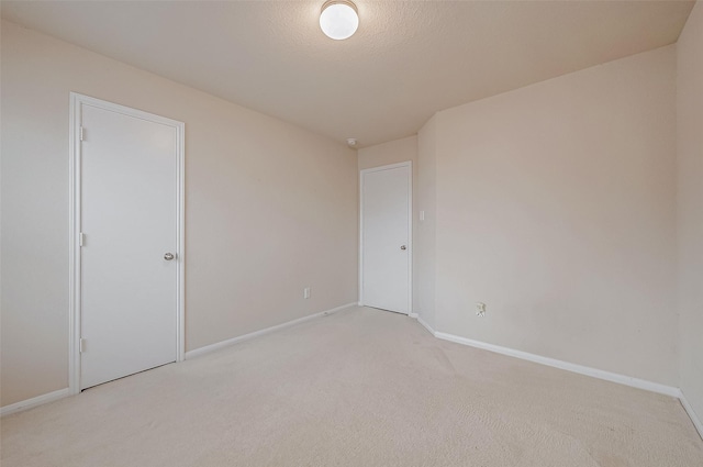 carpeted empty room with a textured ceiling