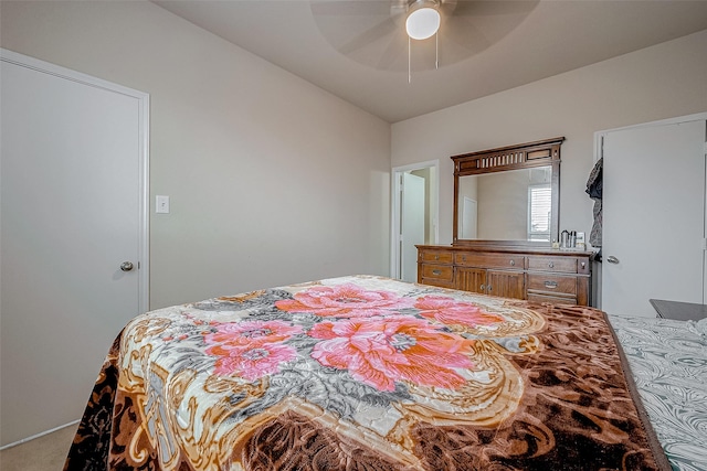 bedroom featuring ceiling fan and carpet