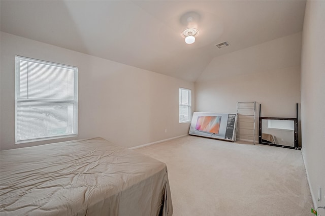 unfurnished bedroom with lofted ceiling and light colored carpet