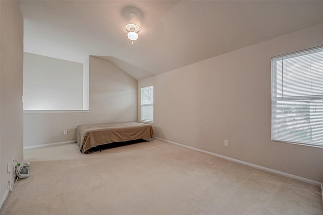 carpeted bedroom featuring lofted ceiling