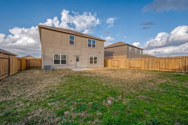 back of property with a patio area, central AC, and a lawn