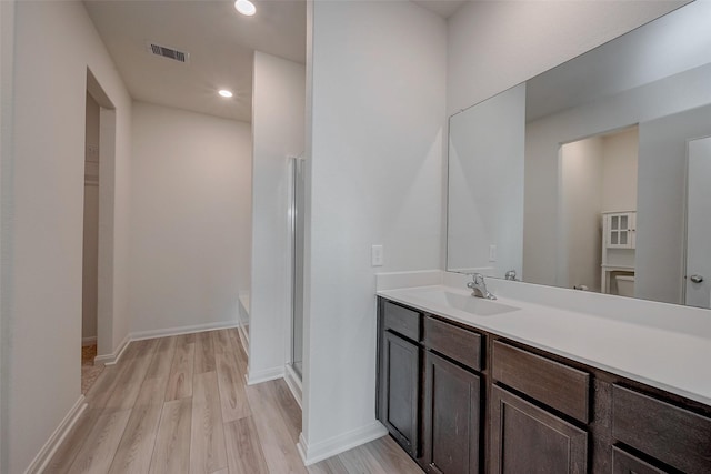 bathroom featuring vanity and hardwood / wood-style flooring